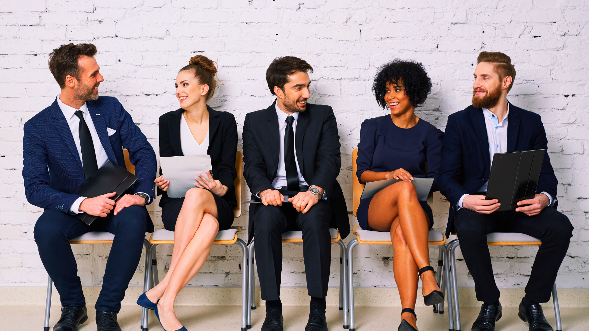 Business executives sitting and smiling while conversing 